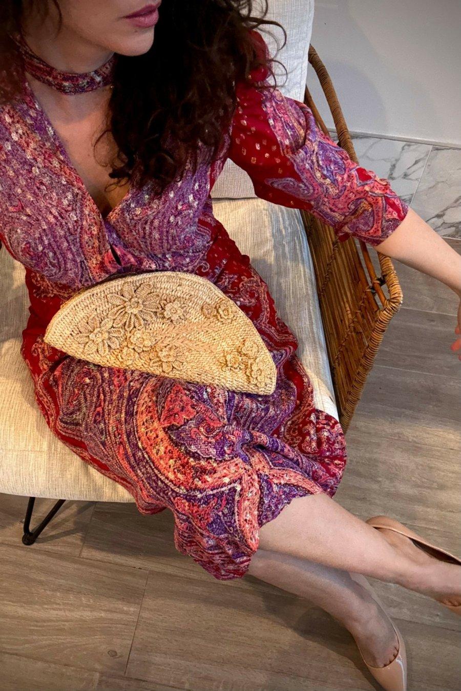 Mademoiselle Lilli featured in CanvasRebel, wearing a paisley dress with a handcrafted woven clutch